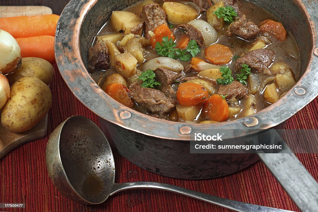 Irish stew in old copper pot Photo of of Irish Stew or Guinness Stew made in an old well worn copper pot.. Beef Stew Stock Photo