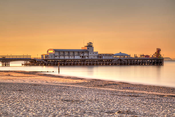 Bournemouth Pier Sunrise Sunrise on Bournemouth Beach with the Pier in the background. bournemouth england photos stock pictures, royalty-free photos & images