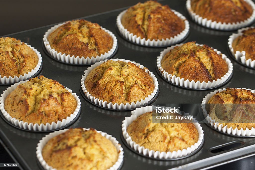 Homemade fresh muffins in oven tray Delicious fresh homemade fruit muffins in a baking tray Banana Muffin Stock Photo