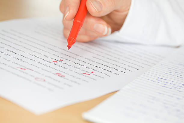 Hand Proofing a Transcribed Page Proofreader with red pen checks a transcription of some hand written text proof reading documents stock pictures, royalty-free photos & images