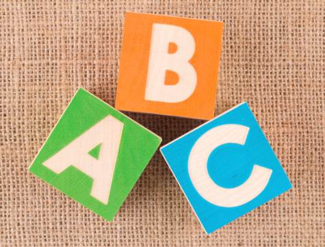Learning through play concept. Wooden blocks spelling ABC.You may also like: