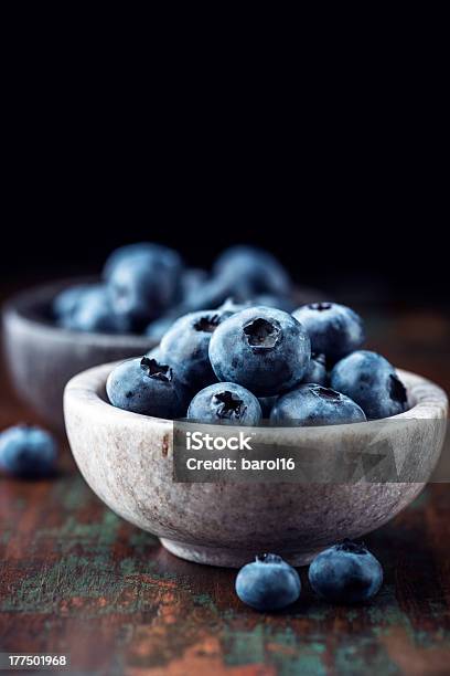 Bilberries In Small Stone Bowls Stock Photo - Download Image Now - Blueberry, Bowl, Black Background