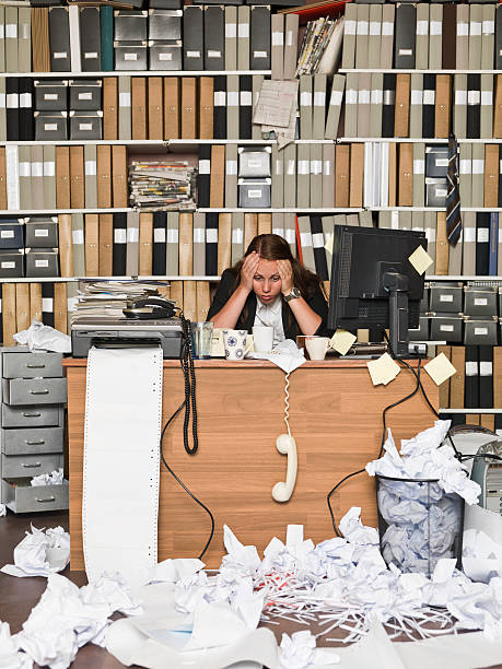 istock Stressed out businesswoman at desk with work overload 177502259