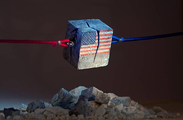 Stars and stripes (USA) tearing Apart Visual Metaphor. Monolithic USA flag being pulled apart by red and blue ropes. Model diorama. democratic party usa stock pictures, royalty-free photos & images