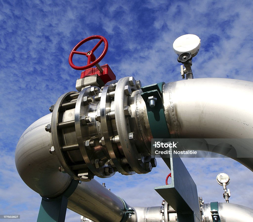 Pipeline di zona industriale, in acciaio e valvole contro il cielo blu - Foto stock royalty-free di Acciaio