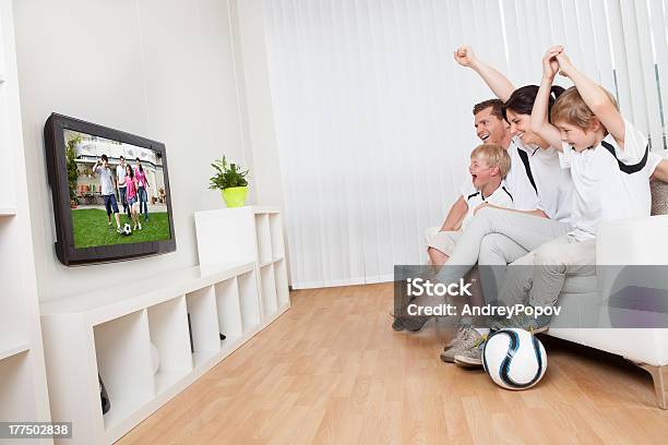 Young Family Watching Football Stock Photo - Download Image Now - Television Set, Family, Watching