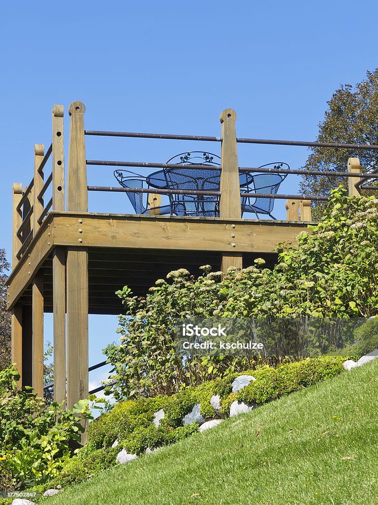 Hillside deck with casual furniture, low angle view Walworth County, Wisconsin, USA. For themes of lifestyle, real estate, gardening, and home improvement. Yard - Grounds Stock Photo