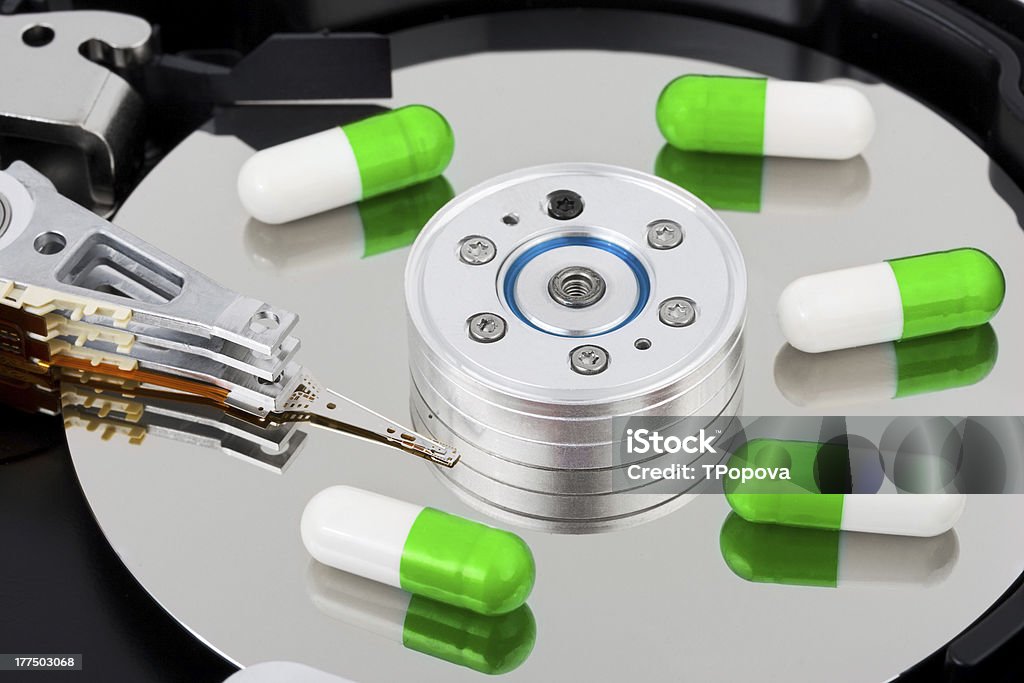 Pills on computer hard drive Pills on computer hard drive - concept technology background Assistance Stock Photo