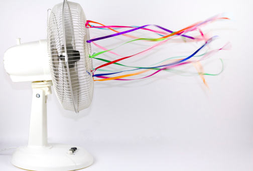 An electric fan blowing colorful silk ribbons