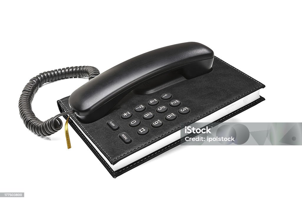 Old office desktop phone with phonebook Old office desktop phone with integrated phonebook concept isolated on white background Yellow Pages Stock Photo