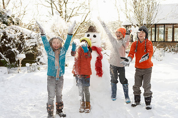 istock Children Building Snowman In Garden 177504888