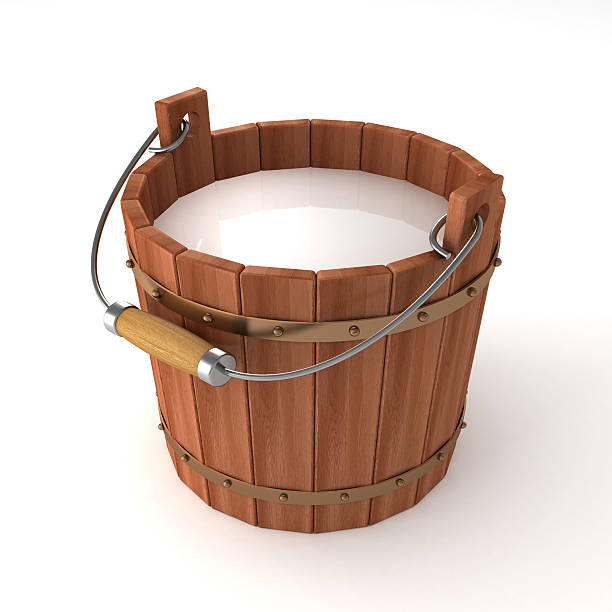 wooden bucket with milk on white background stock photo