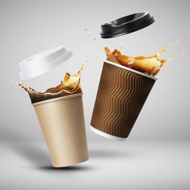 istock Takeaway paper cups with splashing coffee falling on light grey background 1775052763