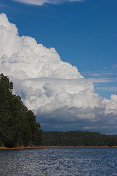 Cumulus Clouds over lake stock photo