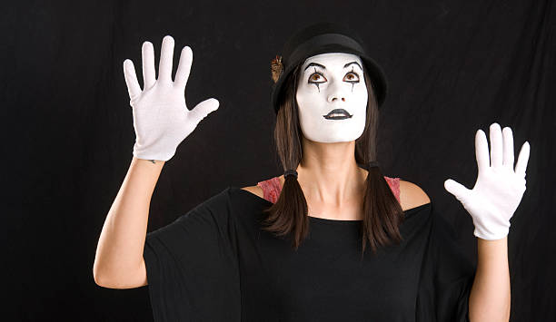 istock Mime Looks and Holds Hands Up in White Face 177505852
