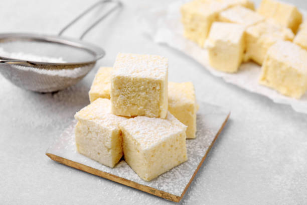 istock Delicious sweet marshmallows with powdered sugar on light grey table 1775066447