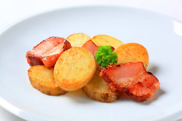 Dish of pan roasted potato slices and bacon