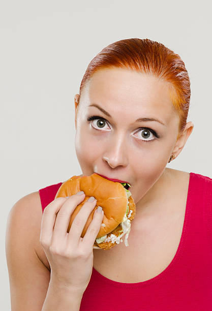 istock Woman eating hamburger 177506927