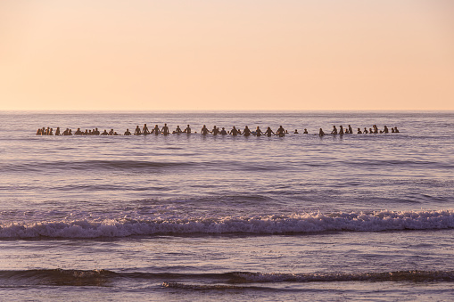 San Diego, California November 2nd 2023: A paddle-out memorial is a tradition that originated in the surfing community, particularly in Hawaii, as a way to honor and remember individuals who have passed away. This unique and meaningful tribute has its roots in the surf culture and has since spread to other coastal communities and beyond.