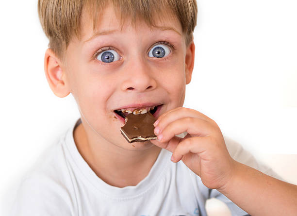 istock Adorable boy eating chocolate 177508161