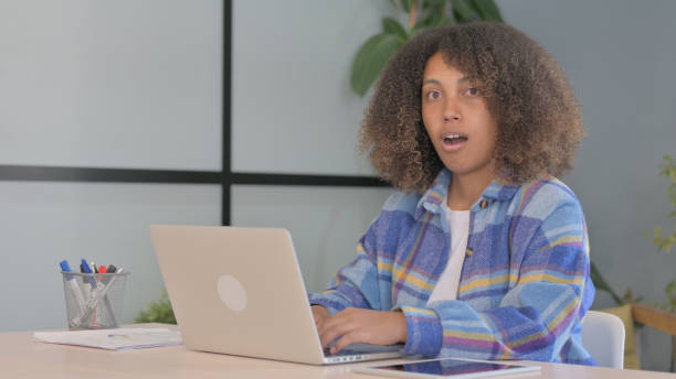 istock Shocked African American Woman Looking at Camera while Working in Office 1775083244