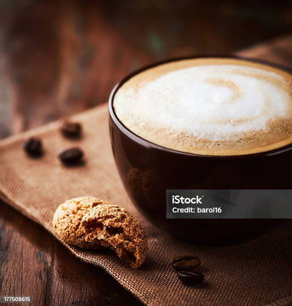 A Cup Of Latte Filled To The Brim With White And Brown Foam Stock Photo - Download Image Now