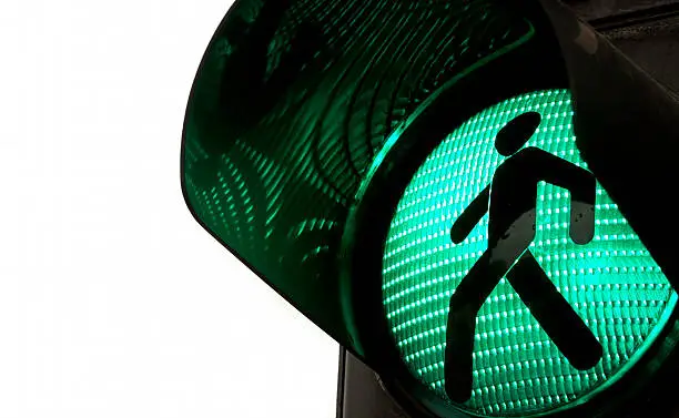 Photo of Walking signal turns green on a traffic light 