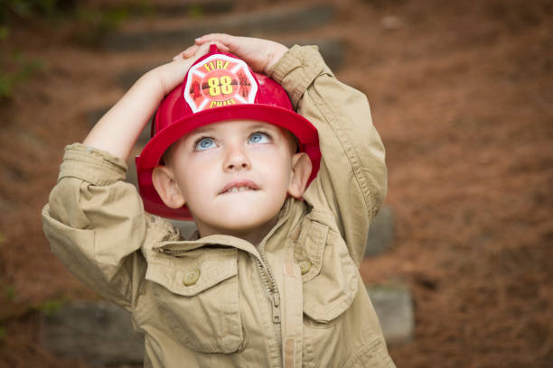 istock Little boy with firefighter hat with hands and eyes up 177508883