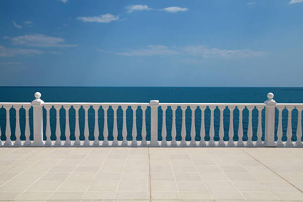 terrace with balustrade overlooking the sea Summer view with classic white balustrade and empty terrace overlooking the sea (Italy) balustrade stock pictures, royalty-free photos & images