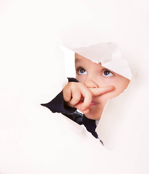 istock Guilty looking kid in a hole of white paper 177509075