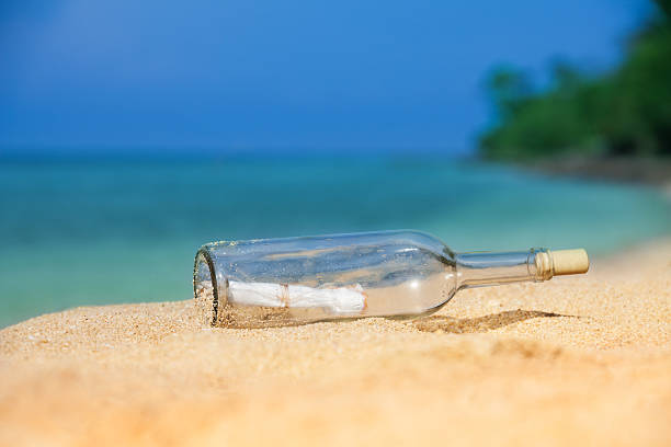 istock bottle with massage on golden sand 177509340