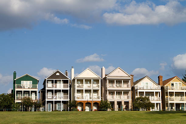 Exterior of a row of upscale townhouses with green grass stock photo