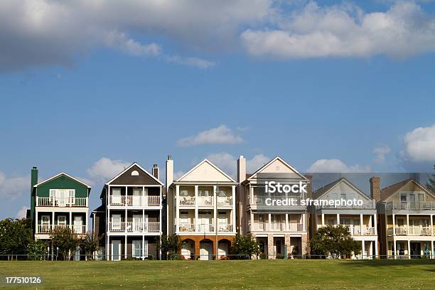 Exterior Of A Row Of Upscale Townhouses With Green Grass Stock Photo - Download Image Now