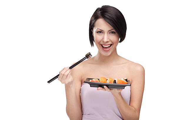 istock Beautiful girl eating sushi with a chopsticks 177510762