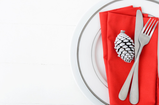 Christmas table setting in red and white, modern simple design with white pine cone as xmas element