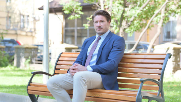 istock Middle Aged Businessman Looking at Camera while Sititng Outdoor 1775109441