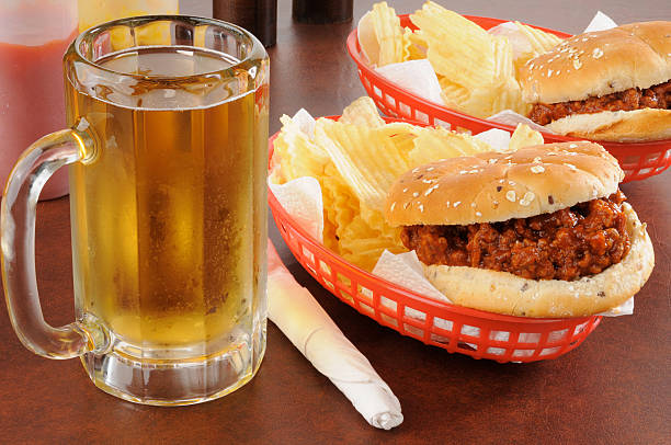 Beer and sloppy Joes A mug of beer and sloppy joes with chips sloppy joes stock pictures, royalty-free photos & images