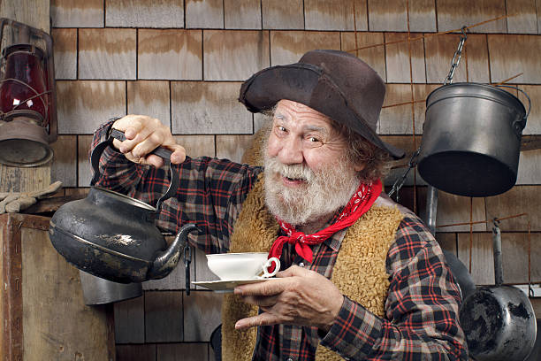 istock Cheerful old cowboy with kettle and china tea cup 177511736