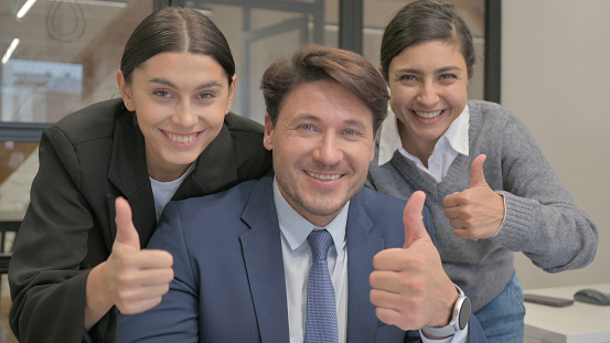 Thumbs Up by Multi Ethnic Business People