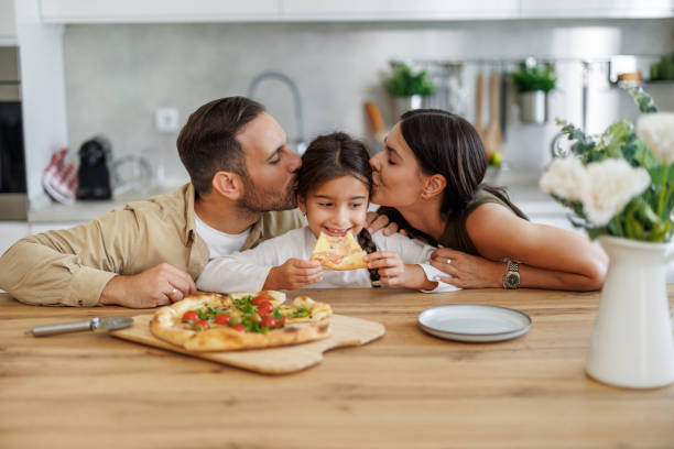 istock Happy family eating pizza at home 1775121122