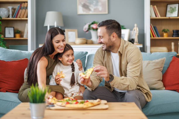 istock Happy family eating pizza at home 1775121126