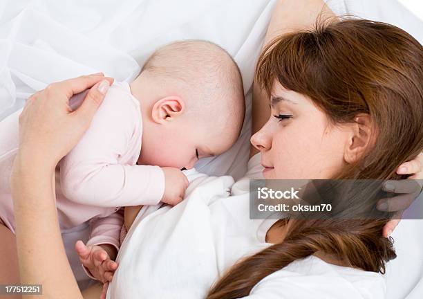 A Mother Breastfeeding Her Baby In Bed Stock Photo - Download Image Now - Breastfeeding, Baby - Human Age, Mother