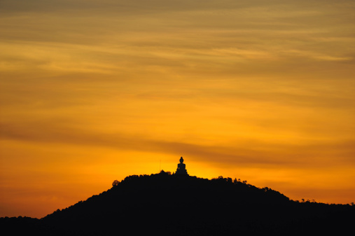 Silhouette of big Buddha on the top of mountain