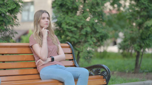 istock Brainstorming Young Woman Sitting Outdoor on a Bench 1775130451
