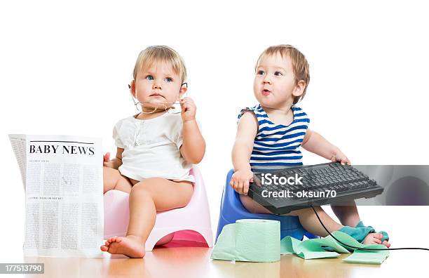Funny Children Girl And Boy Sitting On Chamberpot With Newspaper Stock Photo - Download Image Now