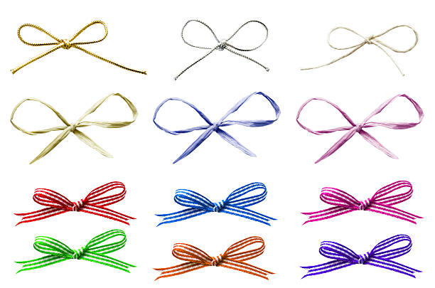 Selection of Tied Bows "A selection of various plain and patterned tied bows in a variety of materials, cut out and isolated on white." raffia stock pictures, royalty-free photos & images