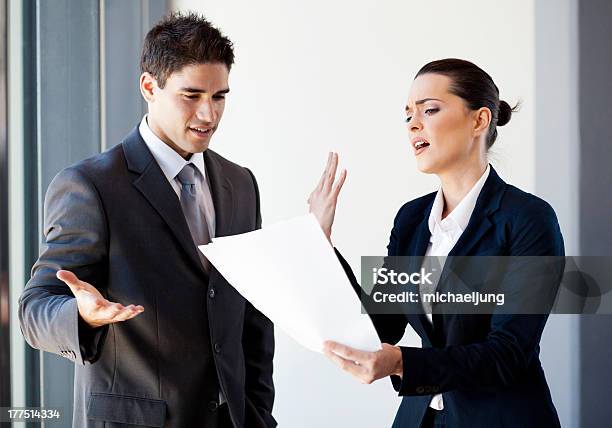 Colleagues Arguing Over Paperwork Stock Photo - Download Image Now - Arguing, Conflict, Business