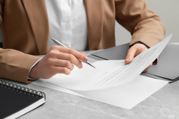 istock Woman signing document at light grey marble table, closeup 1775143556