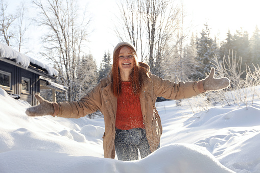Happy woman playing with snow outdoors. Winter vacation