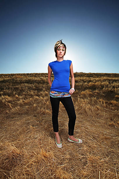 istock Young Woman Standing in Dead Grassy Field 177514518